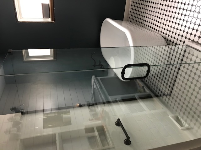 Remodeled bathroom with a freestanding soaking tub and glass walk-in shower