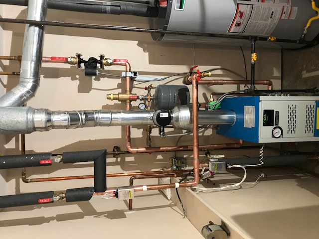 High-efficiency boiler with detailed copper near-boiler piping and water heater in Helena